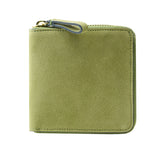 14 of 39:An olive green leather zip-around wallet with a matching leather wrist loop and a gold-tone metal zipper pull, shown on a plain white background.