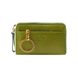 11 of 34:An olive green leather wristlet wallet by TUSK, featuring a gold-tone key ring charm, a top zipper closure, and a small black wrist strap, shown against a plain white background.