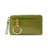 25 of 34:An olive green TUSK wallet with a gold-tone chain and key ring charm, shown on a plain white background.