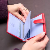 4 of 8:Red wallet with cards inside on a dark background