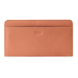 27 of 55:A peach-colored pebbled leather Tusk wallet with a debossed logo on the front, shown against a plain white background.
