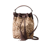1 of 4:Leopard print bucket bag with brown leather accents on a white background