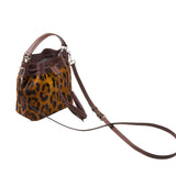12 of 29:Leopard print handbag with brown leather accents on a white background