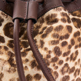 8 of 29:Close-up of a leopard print bag with brown leather straps.