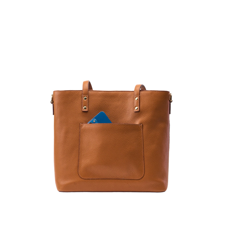 Brown leather tote bag with a blue card in the front pocket on a white background
