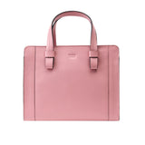 7 of 10:Pink handbag with a visible brand logo on a white background