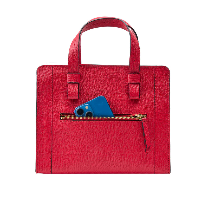 Red handbag with a blue phone in a pocket on a white background