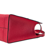 6 of 10:Red handbag with black trim on a white background