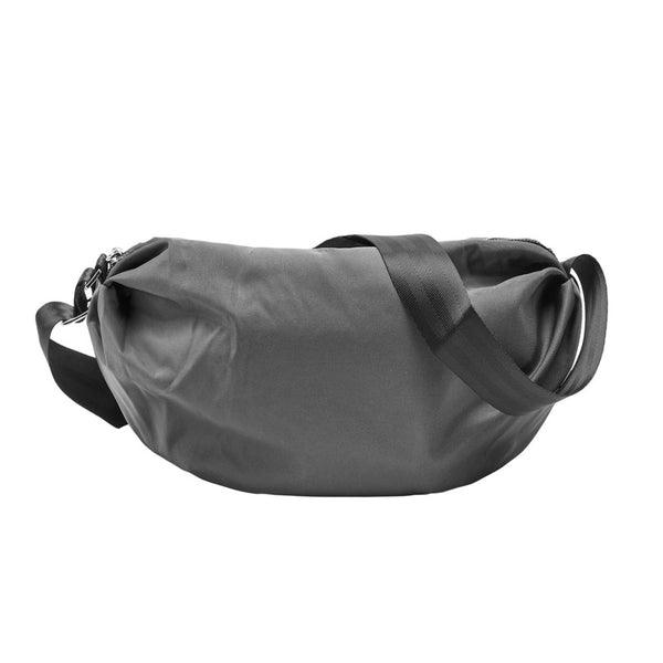 A grey Gotham Neha sling bag with an adjustable black strap and a secure zip closure, displayed against a plain background.