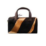 15 of 43:Handbag with zebra stripe pattern on a white background
