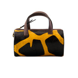 22 of 43:Handbag with dark brown and yellow abstract pattern on a white background