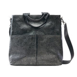 1 of 16:A dark gray textured leather tote bag with dual top handles and a detachable shoulder strap, shown against a plain white background.