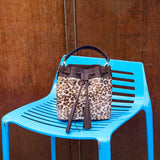3 of 29:Leopard print handbag on a blue chair against a wooden background - BLACK/TAN