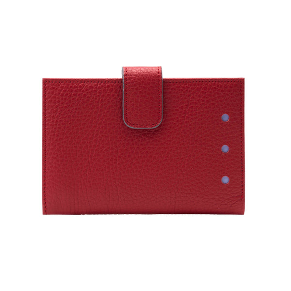 Red leather cardholder with a strap on a white background